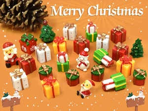 Flat lay of miniature Christmas resin gift boxes, Santa, and snowman festive decorations