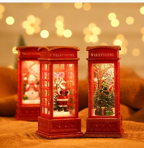 Detail of red Christmas telephone booth lantern with glowing Santa and warm LED lights