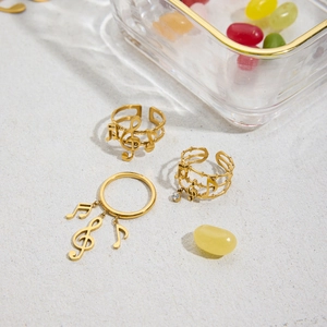 Macro detail of 18K gold stainless steel ring with musical notes and staff design