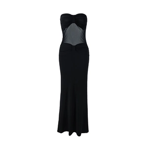 Detail of ruched black strapless dress with transparent mesh panels and flowy skirt