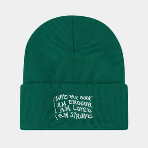 Close-up of white motivational embroidery on cuffed dark green knitted beanie hat