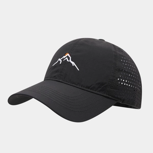 Detail view of laser-cut ventilation holes and mountain embroidery on black sports cap
