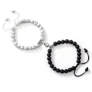 Detail of natural stone magnetic couple bracelets with white turquoise and black agate beads
