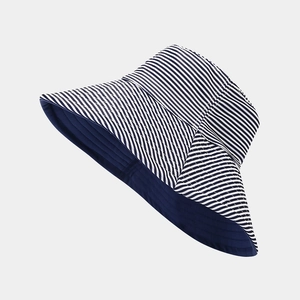 Detail of blue and white striped cotton sun hat with wide brim for UV protection