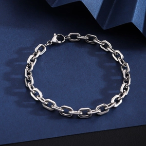Classic silver stainless steel Cuban link chain bracelet with lobster clasp on dark background