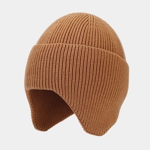 Detail of warm knit earflap hat in camel brown with soft core-spun yarn texture