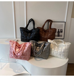 Detailed view of quilted puffer tote bags in black, pink, silver, white and brown