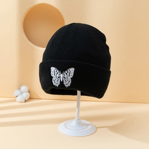 Black knitted beanie hat with white butterfly embroidery and wide fold-over cuff