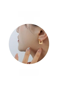 Close-up of elegant square hoop earrings in polished gold plating on a model