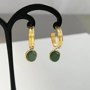 Detail of C-shaped gold hoop earrings featuring hanging round green aventurine stones