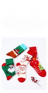 Detailed view of four festive Christmas crew socks with Santa and gingerbread man motifs