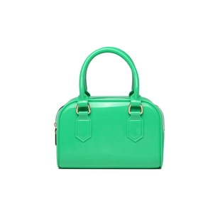 Detailed macro shot of glossy green jelly material and golden hardware on Boston bag