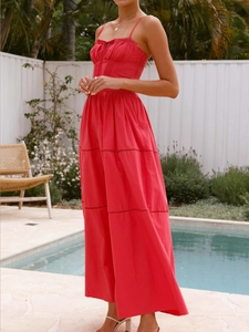 Detail of red tiered maxi dress featuring spaghetti straps and hollow-out lace embroidery