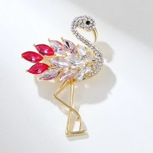 Elegant flamingo crystal brooch in gold-tone metal with red and pink marquise stones