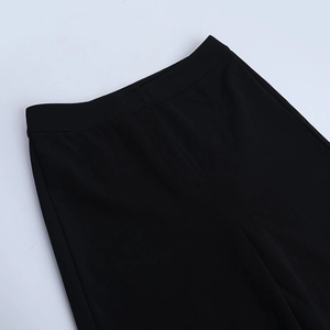Detail of the high-waist band and seamless stitching on these elegant black trousers