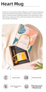 Detail view of hand-painted ceramic mug with heart handle and gold spoon in a gift box