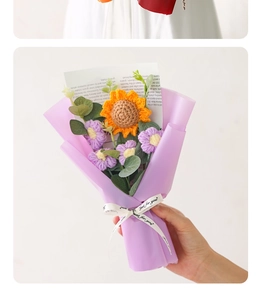 Detail of hand-knitted sunflower bouquet in light purple gift wrap with ribbon