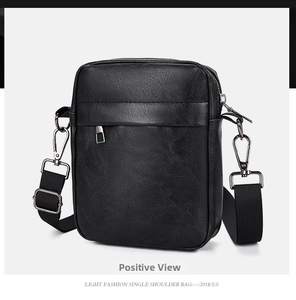 Detail view of black PU leather crossbody bag featuring fine lychee texture and zipper pocket