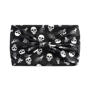 Detailed view of black Halloween headband featuring white skull and skeletal hand prints
