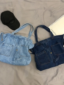 Vintage denim tote bags in light and dark blue with large front pockets and shoulder straps