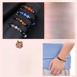 Detailed view of faceted agate and obsidian beaded bracelets on a model wrist