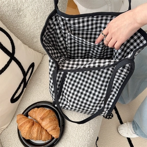 Detailed view of the internal pocket and checkered lining of this fabric tote bag