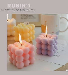 Macro shot of colorful Rubik's cube bubble candles with high-quality cotton wicks