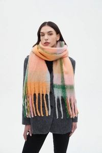 Detail of soft thick checkered scarf with fringes in orange pink and green wool blend