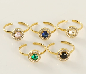 Detail of adjustable 18K gold plated rings with colorful zircon stones in a group display
