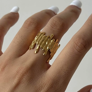 Irregular lava style open ring in gold finish worn on finger for a minimalist look
