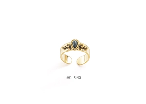 Detail of 18K gold plated ring with hammered texture and water-drop black stone