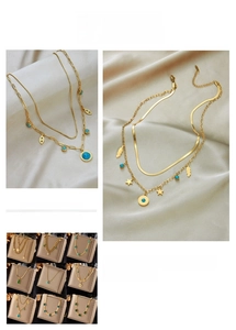 Detail of vintage gold layered necklaces with star pendants and blue turquoise stones