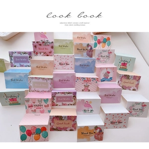 Flat lay of colorful assorted mini greeting cards with floral and cupcake illustrations