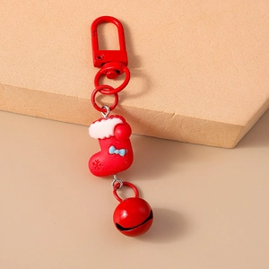 Detail of red Christmas stocking keychain with a matching bell and metal clasp