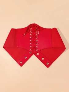 Close-up of red lace-up corset belt with polished leather finish and metal snap buttons