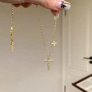 Detail of 24K gold plated cross and flower pendant necklace with fine O-chain link