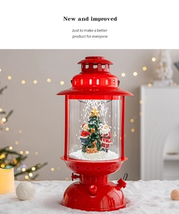 Detail of red Christmas snow lantern with Santa and reindeer scene under warm LED light