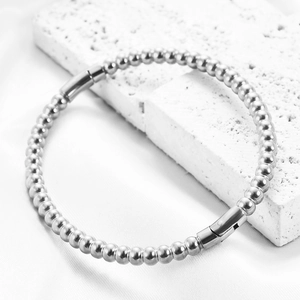 Minimalist 5mm stainless steel beaded bracelet with secure cylindrical clasp on stone