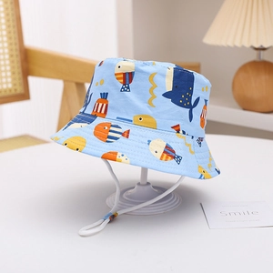 Detail of light blue sun hat with whale patterns and adjustable windproof chin strap