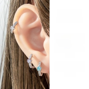 Detailed view of three-piece star-shaped zircon earrings with micro-set small crystals