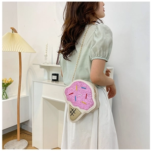 Pink glitter ice cream crossbody bag with gold chain strap shown on a model outfit