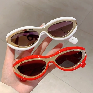 Retro Y2K cat-eye sunglasses with white and red frames and gold metal accents