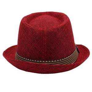 Detail of red woven fedora hat featuring a classic striped band on white background