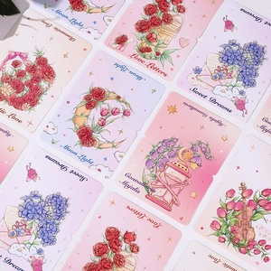 Flat lay of floral and fantasy greeting cards featuring moon, rose, and romantic lettering