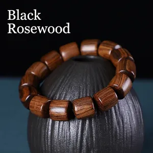 Authentic black rosewood barrel bead bracelet with natural wood grain on ceramic pot