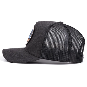 Side view of dark gray trucker hat featuring embroidered patch and breathable mesh back