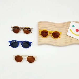 Set of four colorful round kids sunglasses with matte frames and UV protective lenses