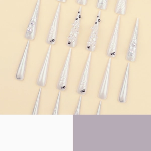 3D aurora butterfly stiletto press-on nails with pearls on creamy background