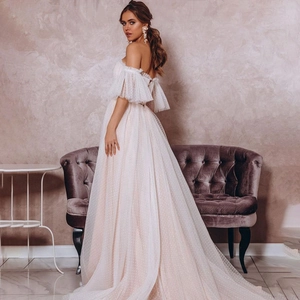 Elegant ivory off-shoulder wedding dress with polka dot tulle and bubble sleeves