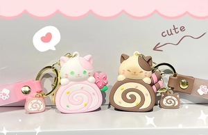 Close-up of cute cat cake roll keychains in pink and brown with silicone hand straps